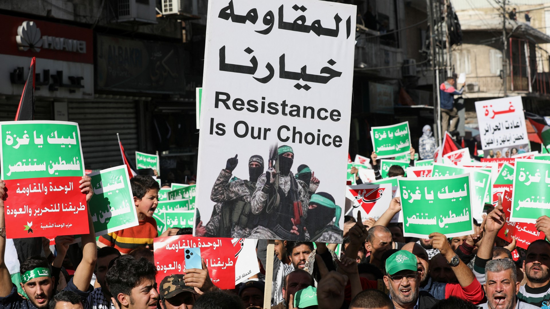 People hold placards during a protest in support of Palestinians in Gaza, in Amman, Jordan December 1, 2023. REUTERS/
