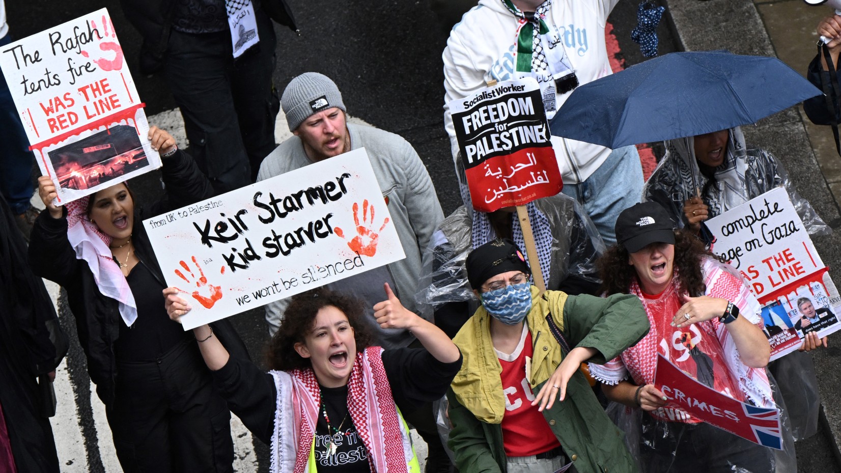 Pro-Palestinian protesters holding placards against Britain's new Prime Minister Keir Starmer shout slogans as they march during the "National March for Gaza", calling to "end the genocide" and "stop arming Israel", on July 6, 2024