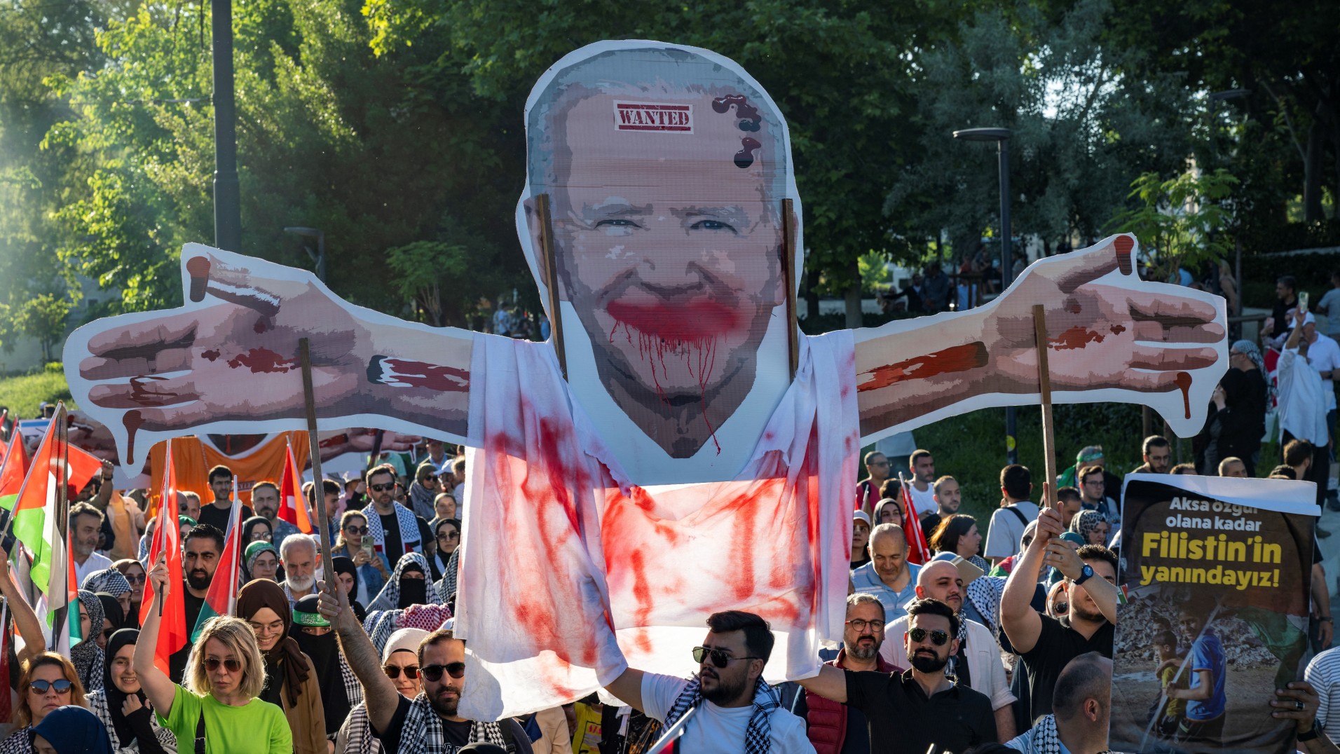 Pro-Palestinian protesters march with a cardboard cutout depicting US President Joe Biden in Istanbul on 1June, 2024 (AFP)