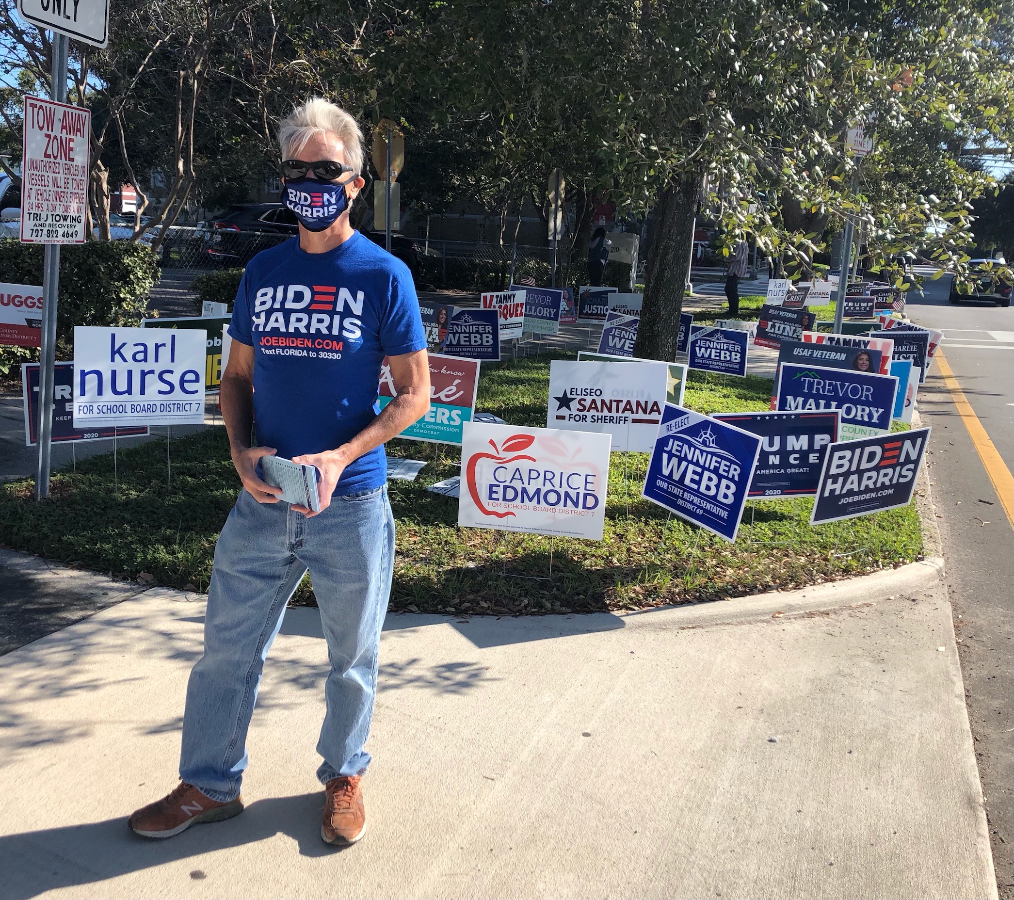 Robert, originally British but a registered US voter for almost a decade, stands outside a polling place to show his support for presidential nominee Joe Biden on 3 November (MEE/Sheren Khalel)