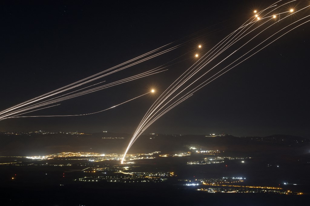 Rockets fired from southern Lebanon are intercepted by Israel's Iron Dome air defence system over the Upper Galilee region in northern Israel, on 4 August 2024 (Jalaa Marey/AFP)