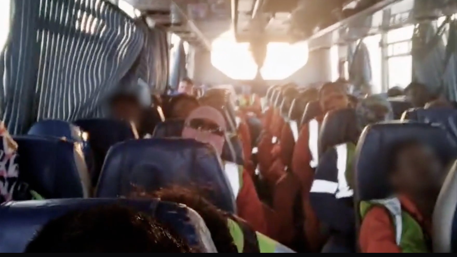 Workers who are building The Line commuting in a crowded bus are captured in undercover footage (ITV)