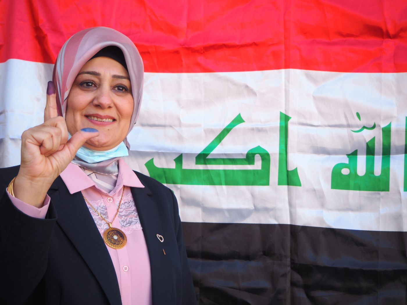 Candidate Sawsan Jadou shows ink-stained fingers after voting in Kirkuk on 10 October 2021 (MEE/Tom Westcott)