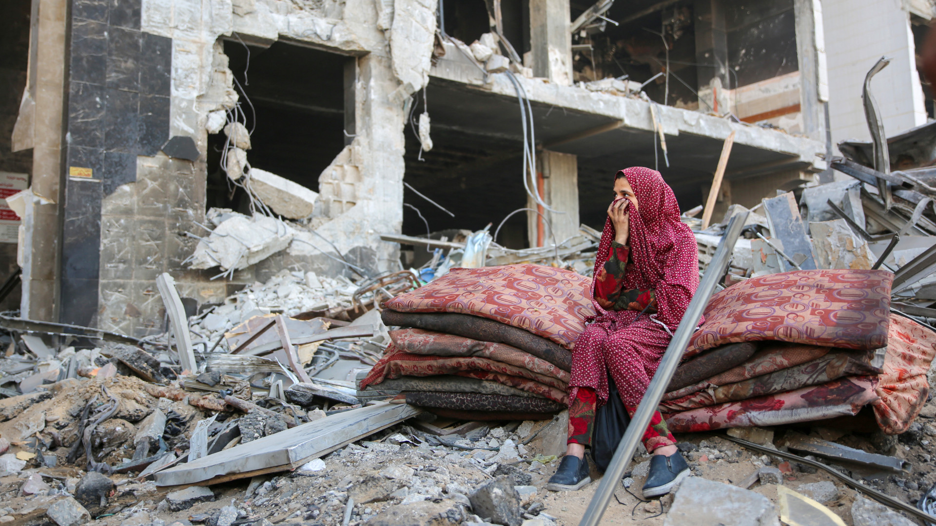 A Palestinian woman reacts as she sits amid the rubble of Gaza's al-Shifa hospital after an Israeli military attack on the complex on 1 April (AFP)