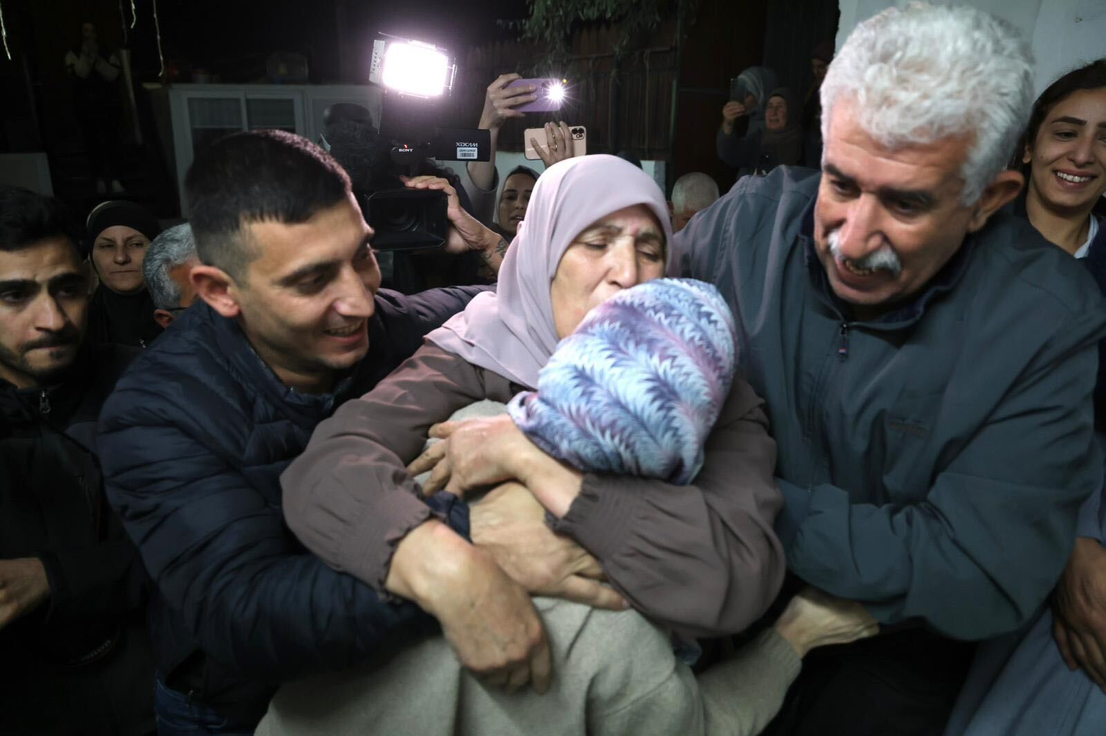 Shorouq Dwayyat's mother hugs her daughter (MEE/Faiz Abu Rmeleh)