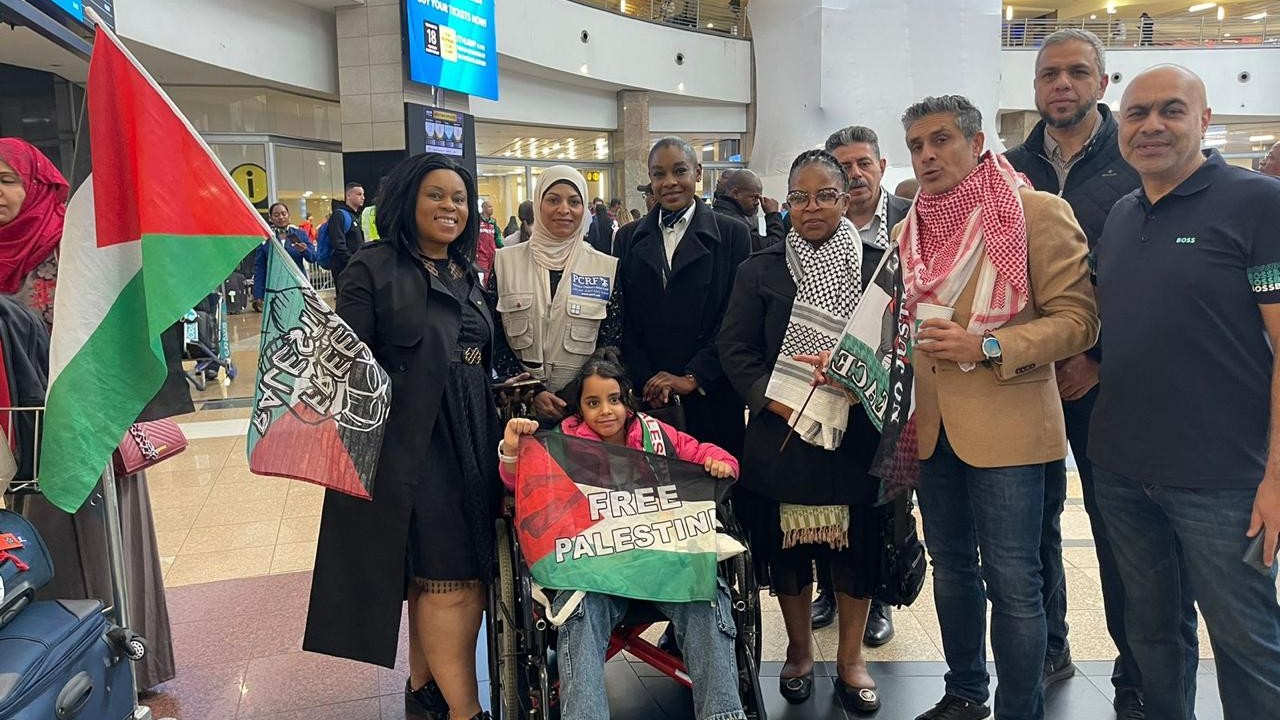 Mira, 9, surrounded by supporters at OR Tambo International Airport in Johannesburg on Friday (PCRF)