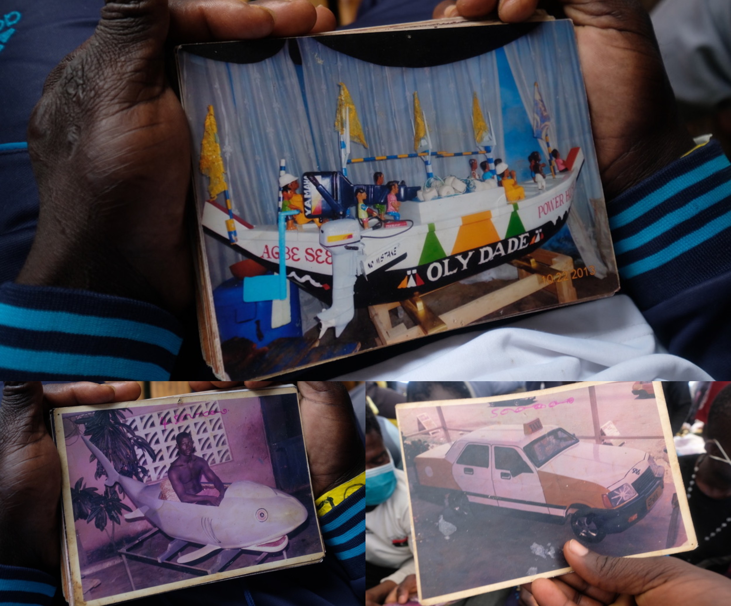 Stephen Donkoh proudly showed photographs of his work - including coffins shaped like fishing boats, sharks or taxi cabs (MEE/Karlos Zurutuza)