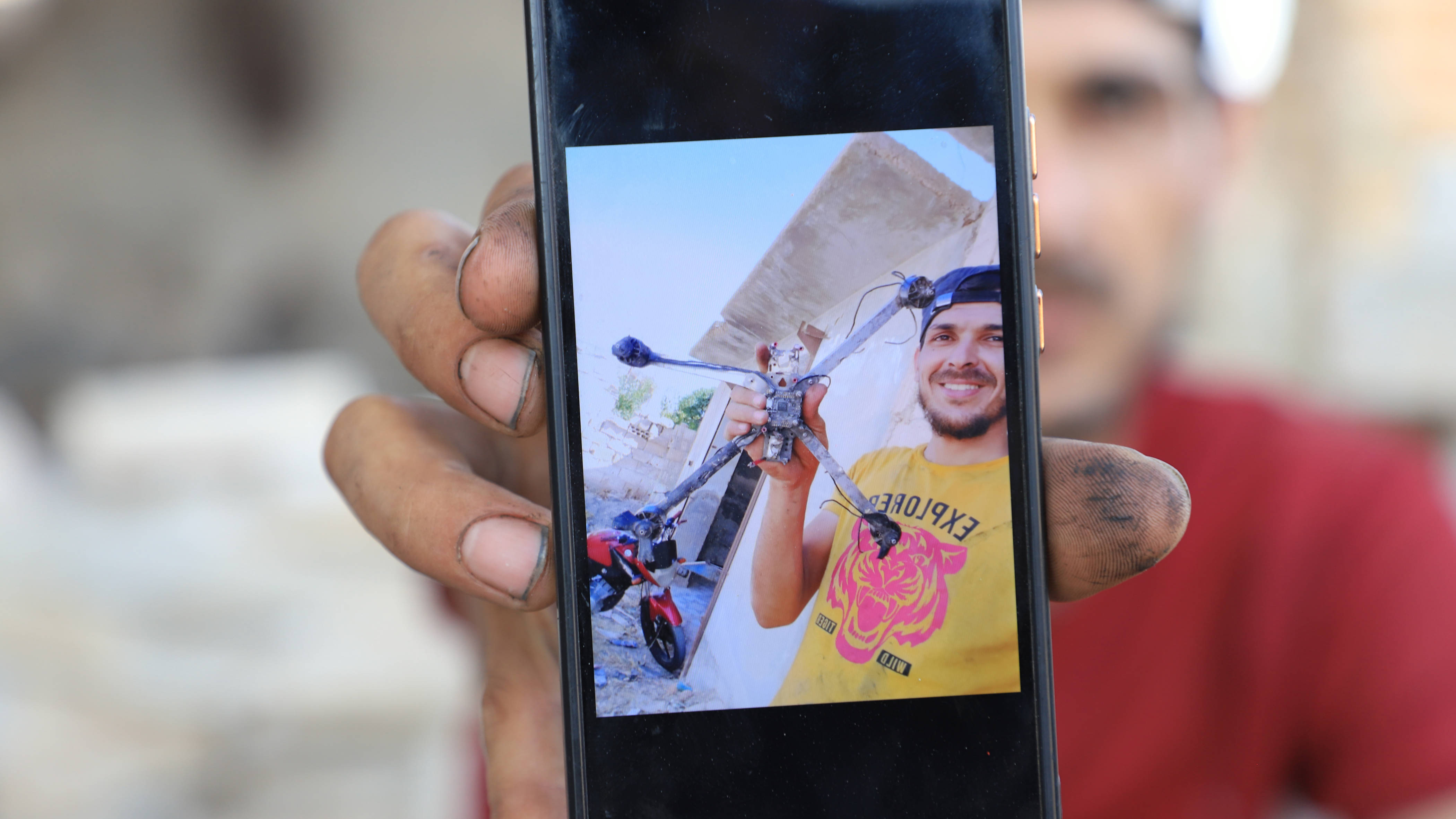 Abdul Rahman al-Mohammed shows an image of a drone he shot down with his rifle (Abd Almajed Alkarh/MEE)