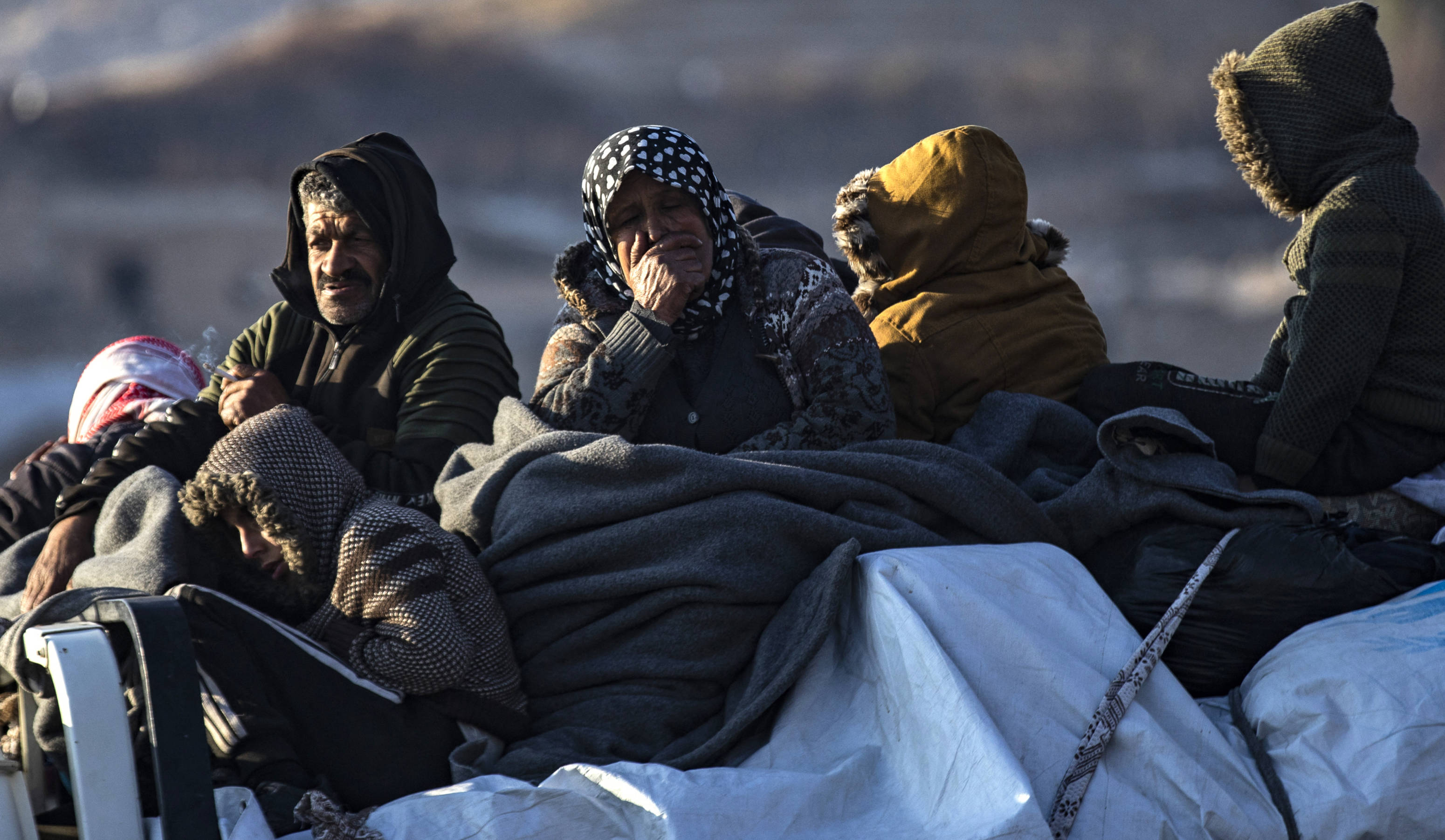 Syrian Kurds, fleeing their homes in the outskirts of Aleppo city after they were seized by rebels, arrive with their belongings to Tabaqah, on the western outskirts of Raqqa, on 2 December 2024 (AFP)