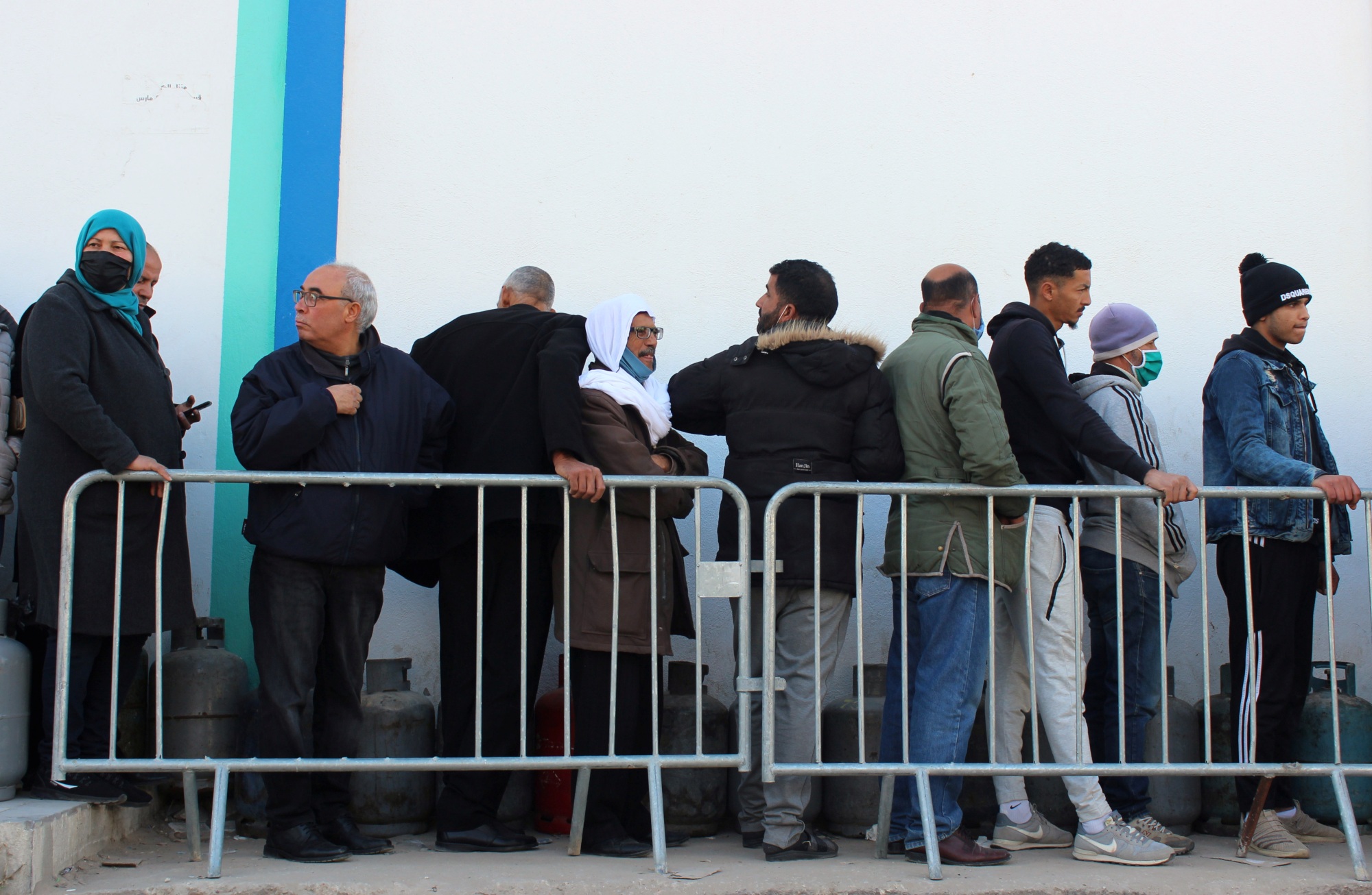 People queue as they wait to get cooking gas outside a main outlet in Sidi Bouzid, Tunisia, on 8 December 2020 (Reuters)