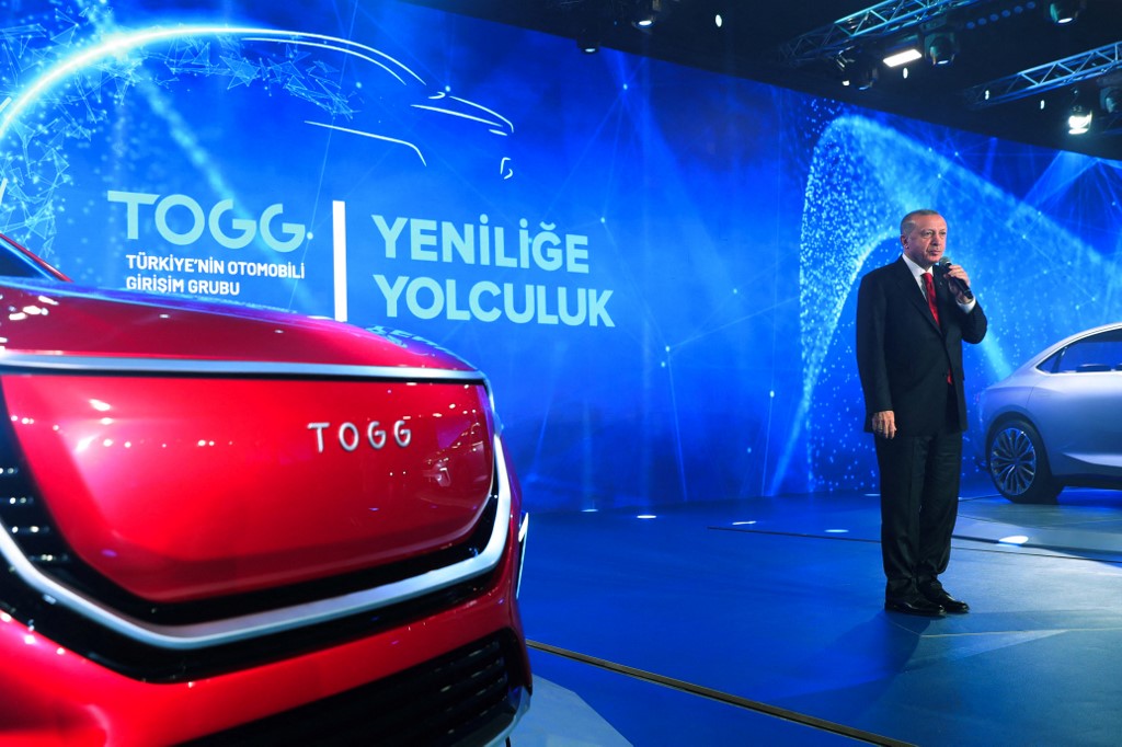 Turkish President Recep Tayyip Erdogan delivering a speech next to the firsts Turkish made electric cars by the TOGG company, during the launching ceremony in the Gebze district of Kocaeli