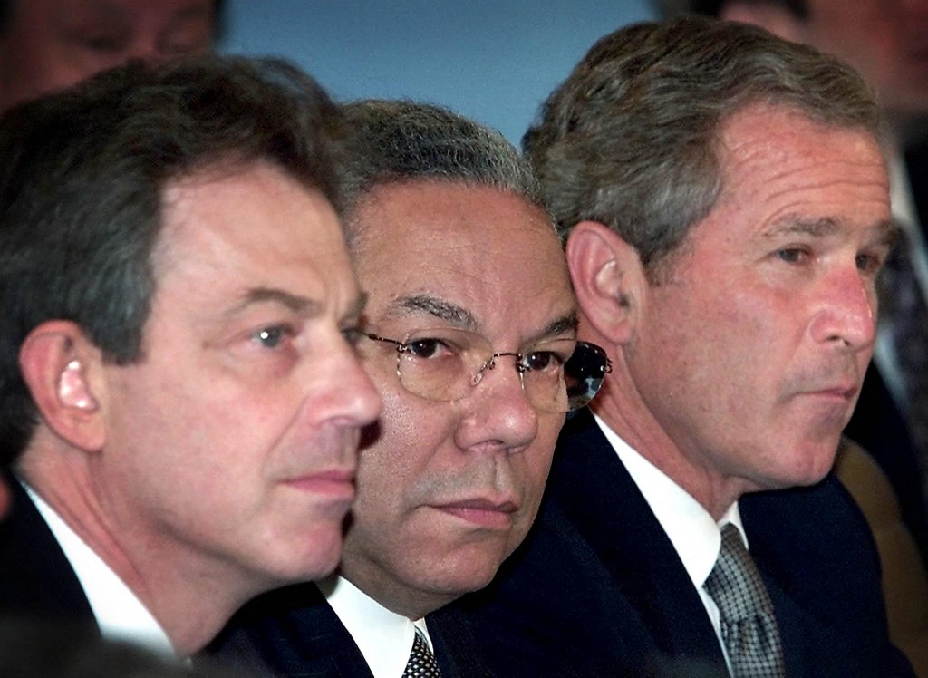 US President George W Bush (R), Secretary of State Colin Powell (C) and British Prime Minister Tony Blair (L) attend a briefing at Nato Headquarters in Brussels, 13 June 2001 (AFP)