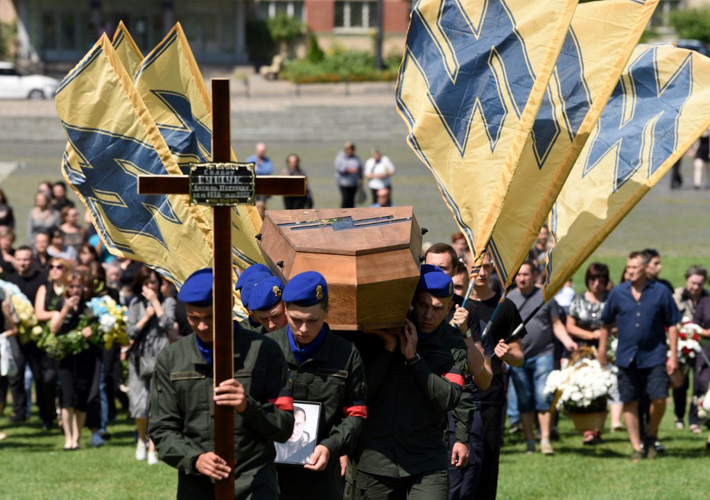 Ukrainian soldiers carry the coffin of a serviceman from the ultra-nationalist Azov regiment killed during the Russian invasion of Ukraine, in Lviv, on 29 July 2022 (AFP)