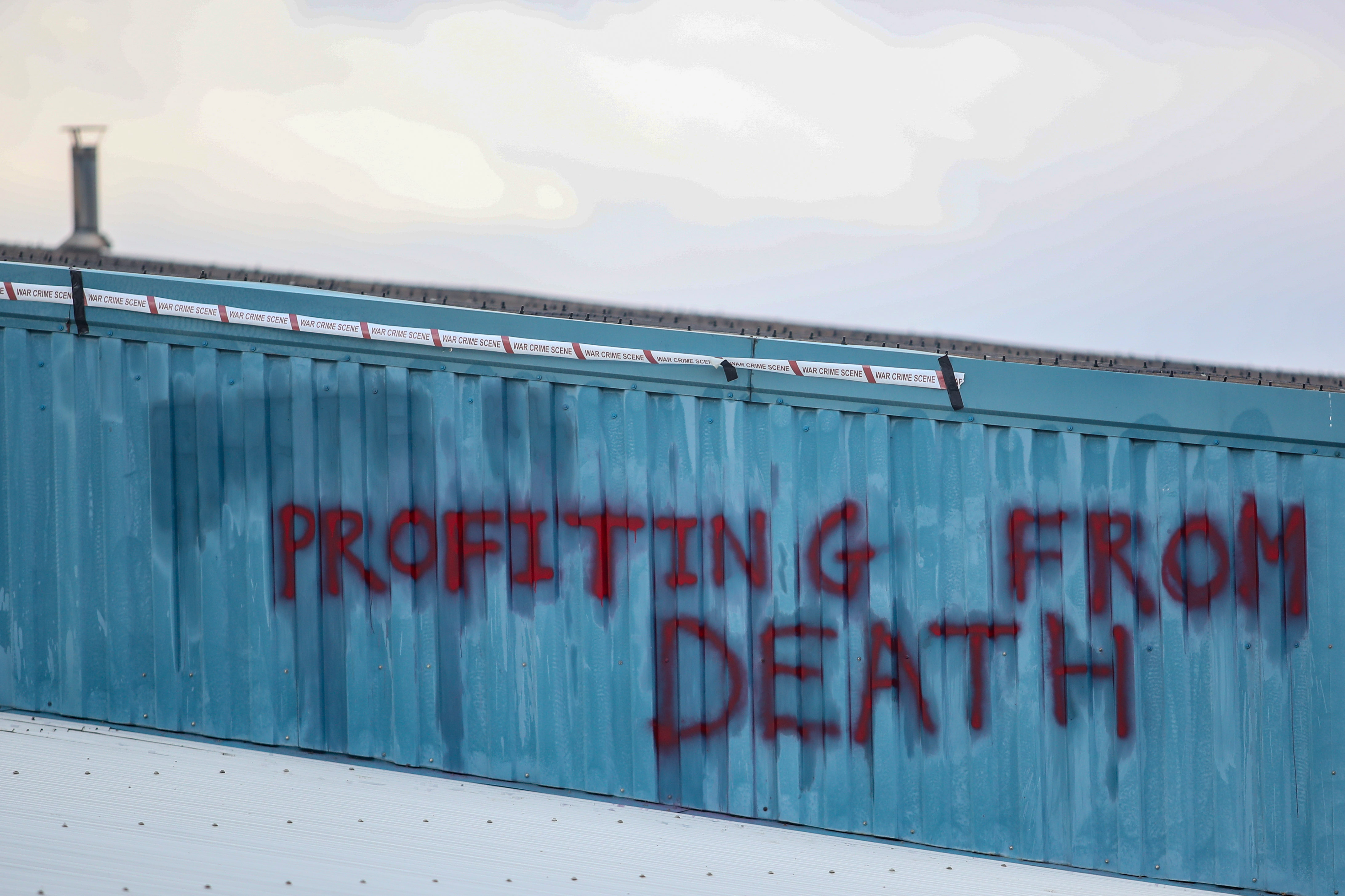The front of the factory was spray-painted with the words "profiting from death"