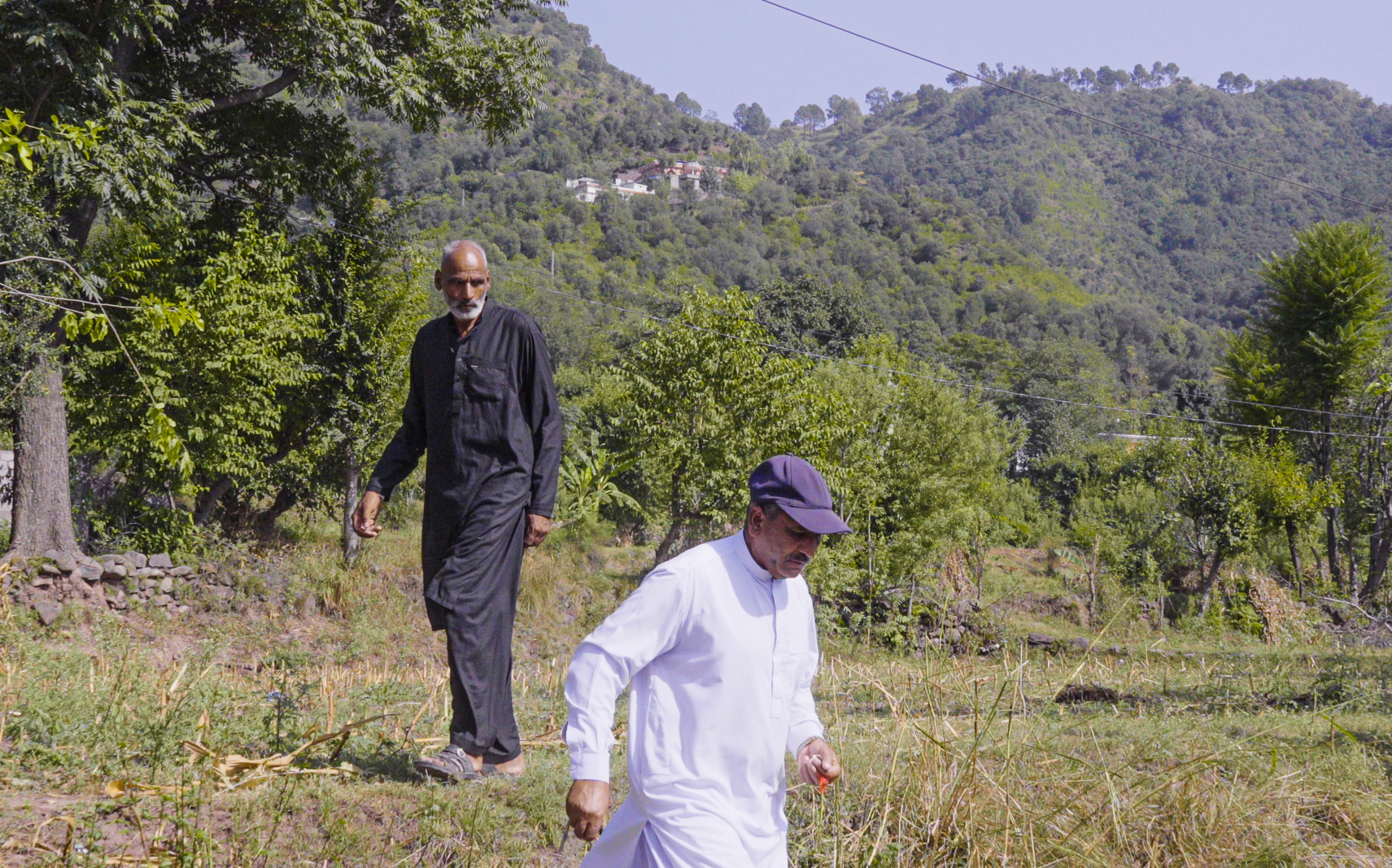 Village elder, Mohammad Riaz- behind him is the hills where army posts are located (Photo: Huthifa Fayyad/MEE)