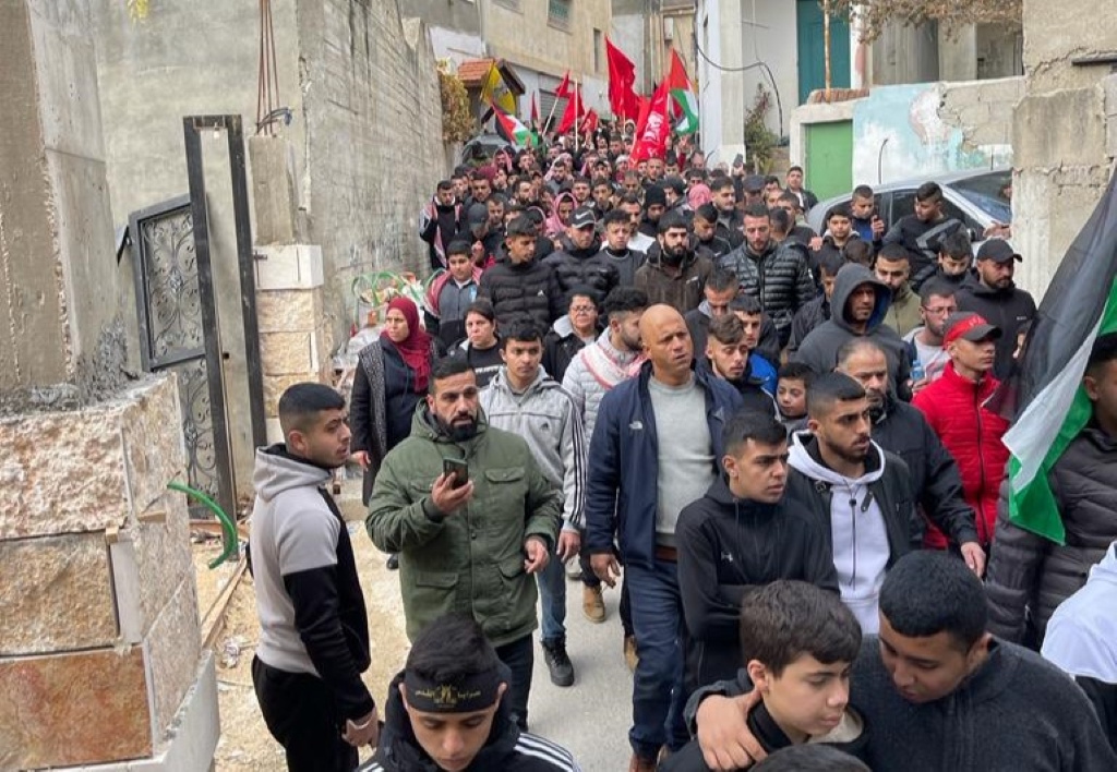 Mourners follow a procession carrying the body of Adam Essam Ayyad (Akram al-Waara)