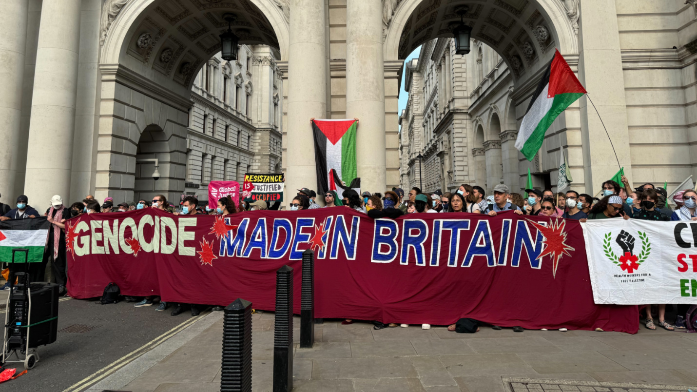 Workers and trade unionists blocking access to the Foreign, Commonwealth and Development Office (FCDO) headquarters in London on 24 July 2024 (Mohammad Saleh/MEE)