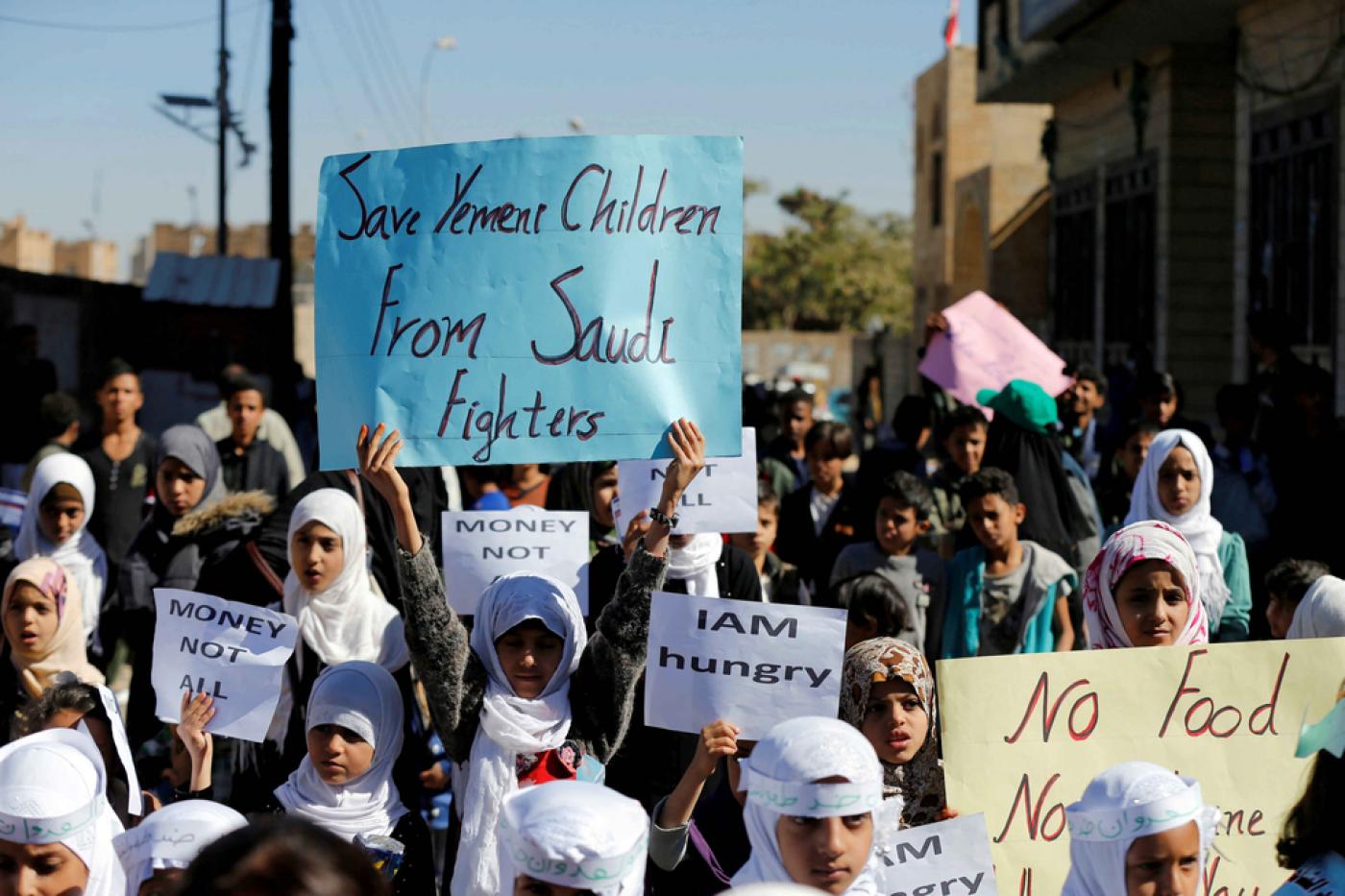 Children protest against the Saudi-led coalition outside the UN offices in Sanaa in 2017 (Reuters)