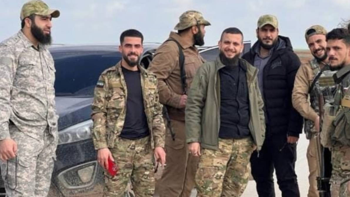 Two brothers (middle) of former HTS leader Abu Ahmed Zakour stand between Turkish-backed Syrian rebels (provided)
