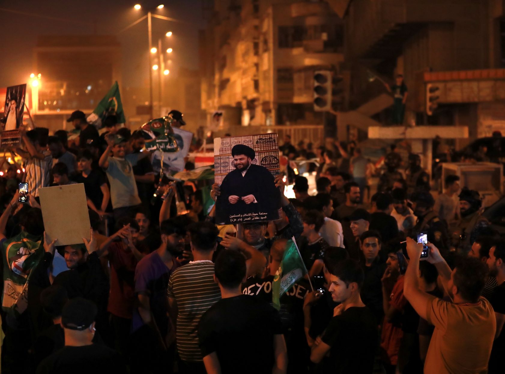 Supporters of cleric Muqtada al-Sadr celebrate in Tahrir Square in Baghdad (MEE/Murtaja Lateef)