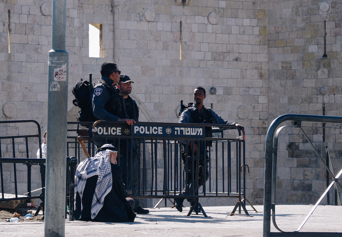 A Palestinian man waits to enter Jerusalem's Old City for Friday prayers after Mohammed Abu Khalaf was shot dead after an alleged stabbing attack