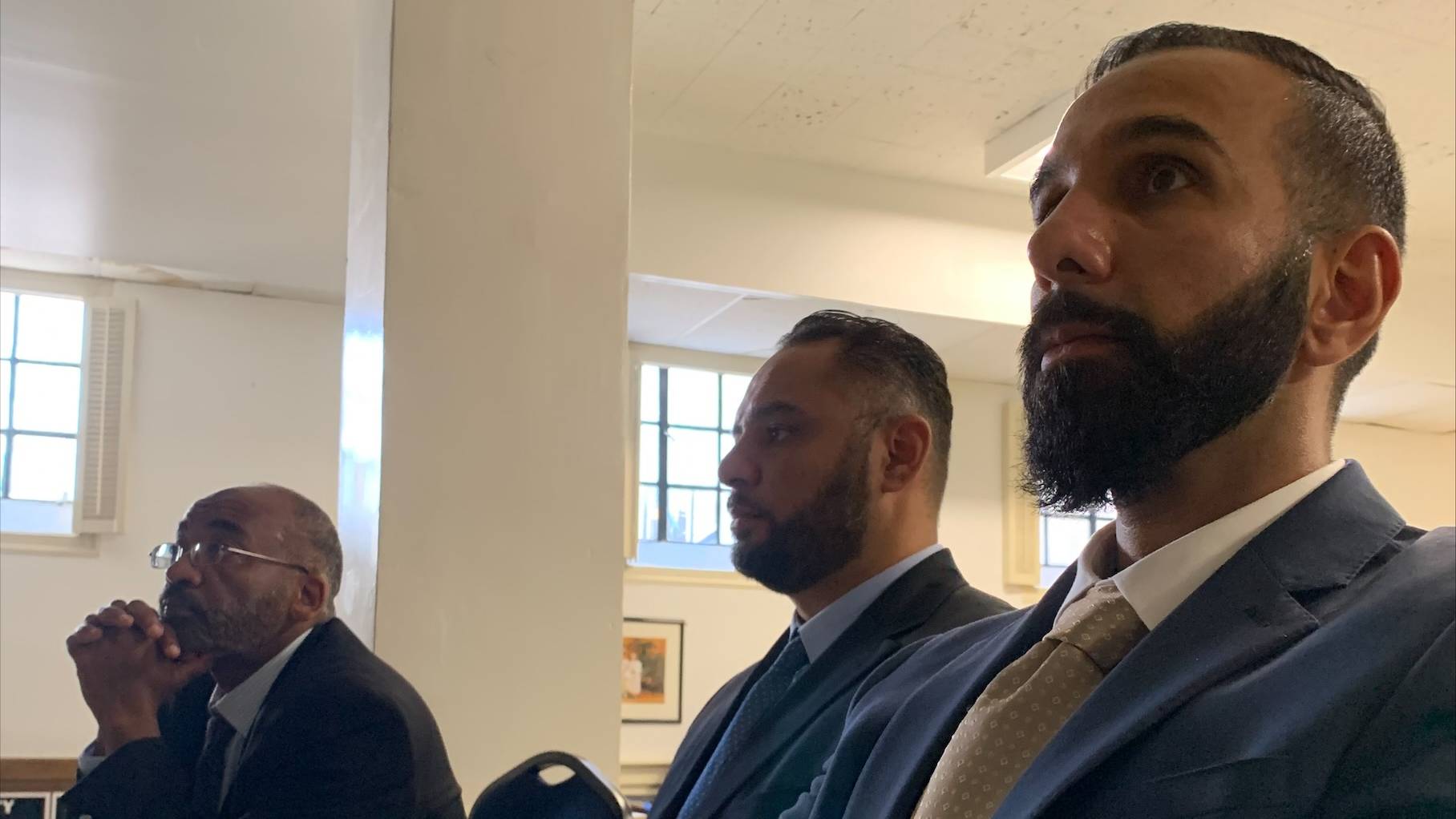 Imam Yassir Fazaga (L), Yasser Abdelrahim (C) and Ali Uddin Malik (R) watch oral arguments at the Supreme Court on 8 November.