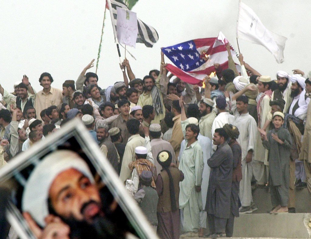 Pro-Taliban protesters torch a US flag in Quetta, Pakistan, in 2001 (AFP)