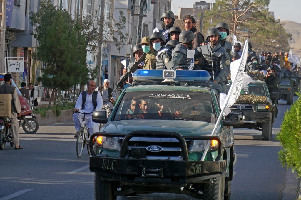 Newly recruited Taliban fighters parade in vehicles after their graduation ceremony in Herat, Afghanistan, on 13 September 2022 (AFP)
