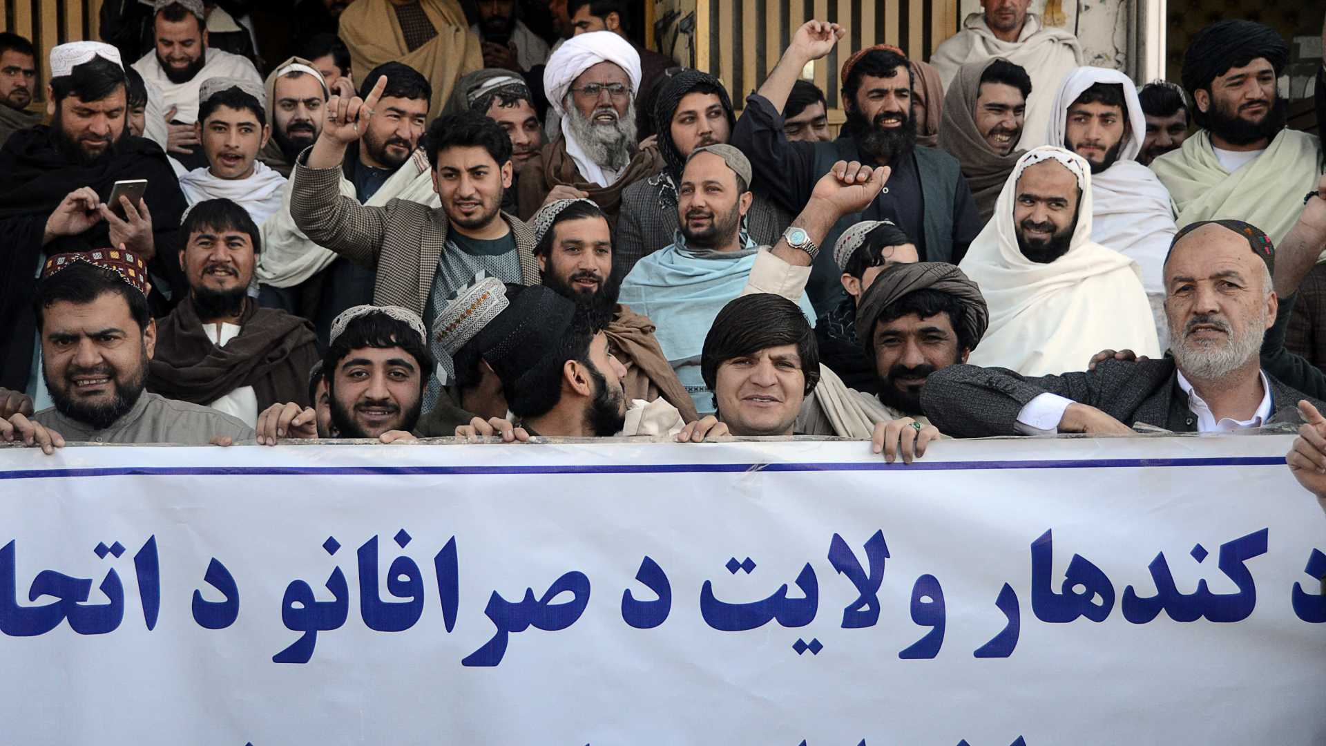 Businessmen and money changers participate in a protest against the recent remarks by U.S. President Joe Biden to freeze Afghanistan's assets, in Kandahar on February 15, 2022.