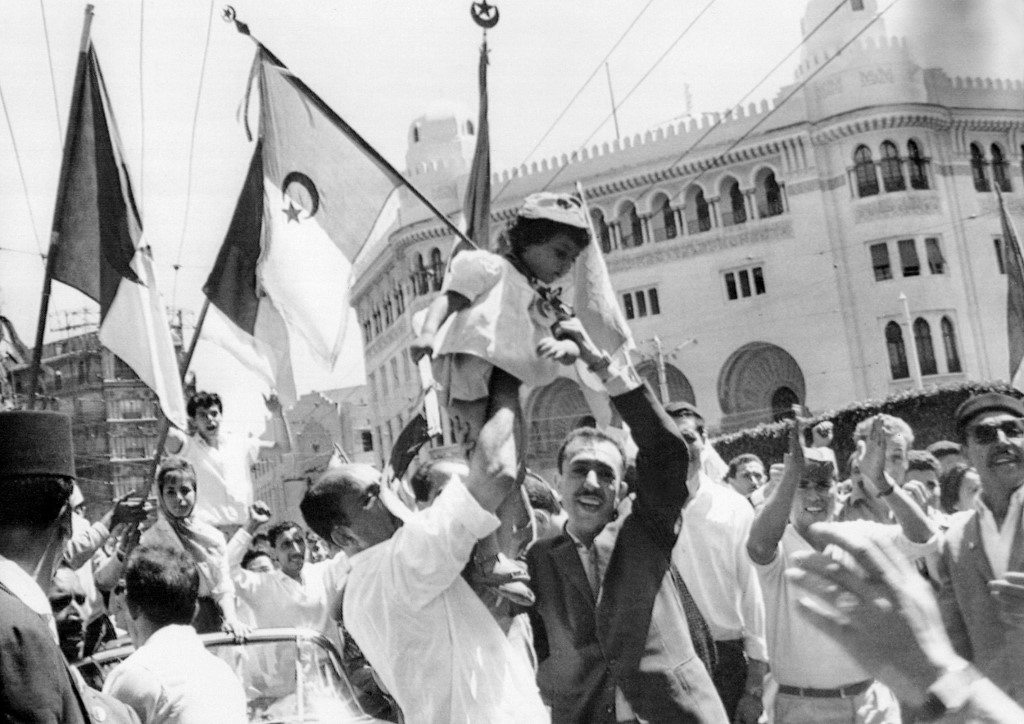 A crowd of Algerians celebrate independence in Algiers in 1962 (AFP)