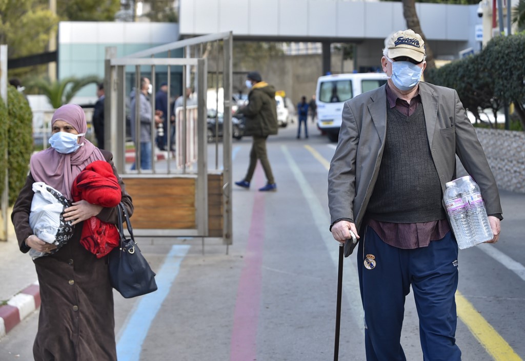 People wear protective masks in Algiers on 26 February (AFP)