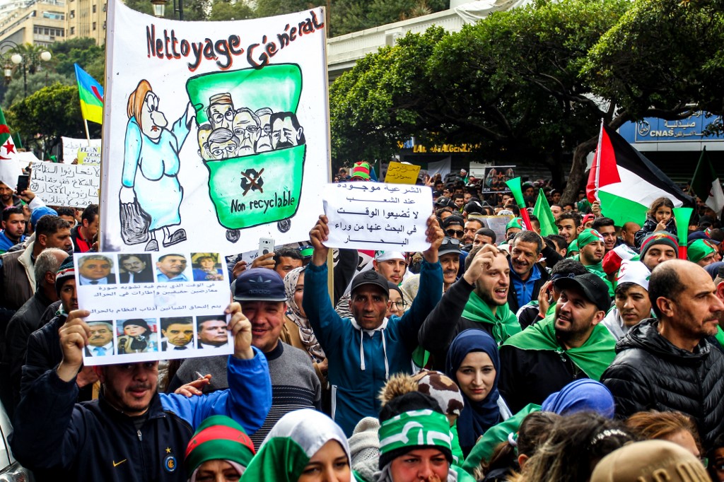 Algerians take part in anti-government protests in Algiers on 22 March (AFP)