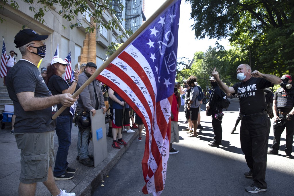 The Proud Boys, an alt-right group, face off with Black Lives Matter protesters on 15 August 2020 in downtown Portland, Oregon (AFP)