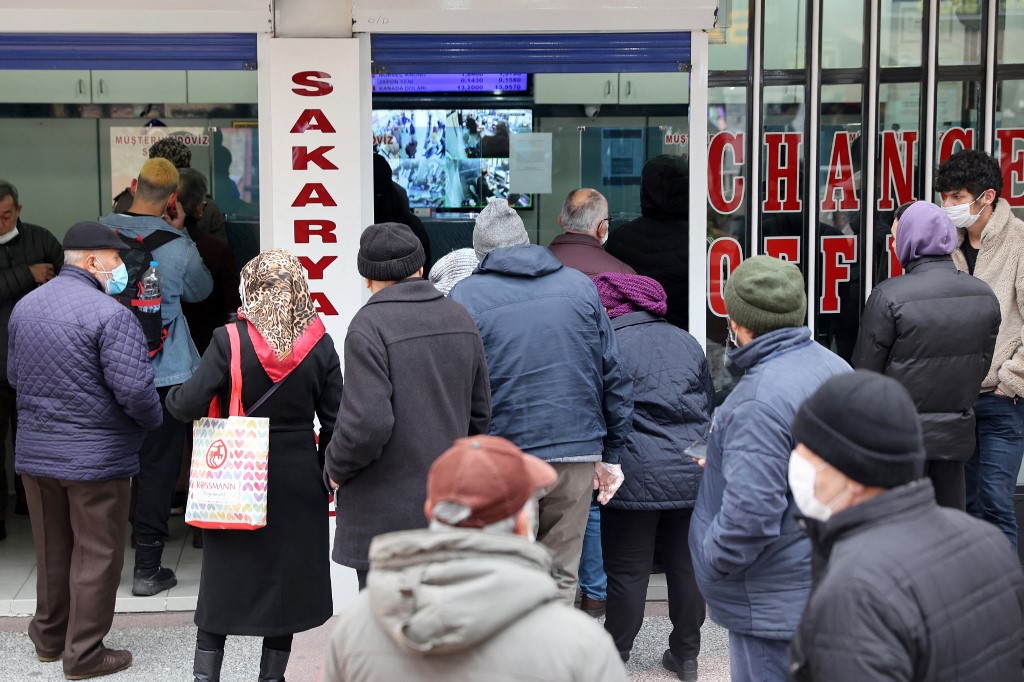 People queue outside a currency exchange shop in Ankara in December 2021 (AFP)