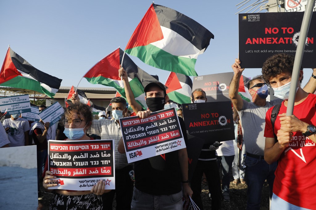 Palestinian and Israeli activists protest annexation south of Jericho on 27 June (AFP)