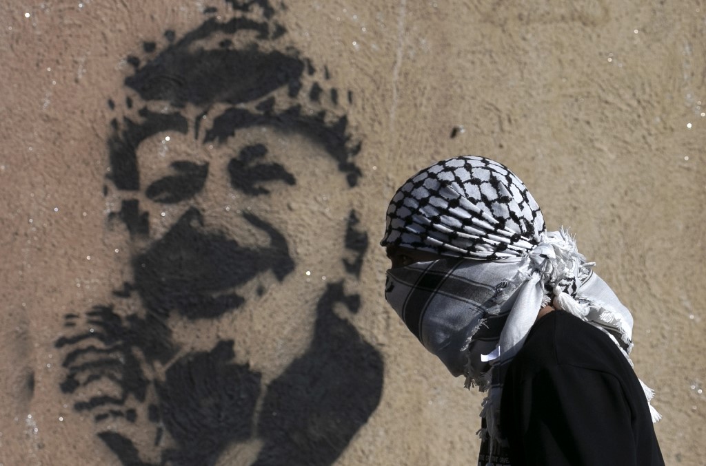 Graffiti of late Palestinian leader Yasser Arafat is pictured in Jenin on 7 February (AFP)