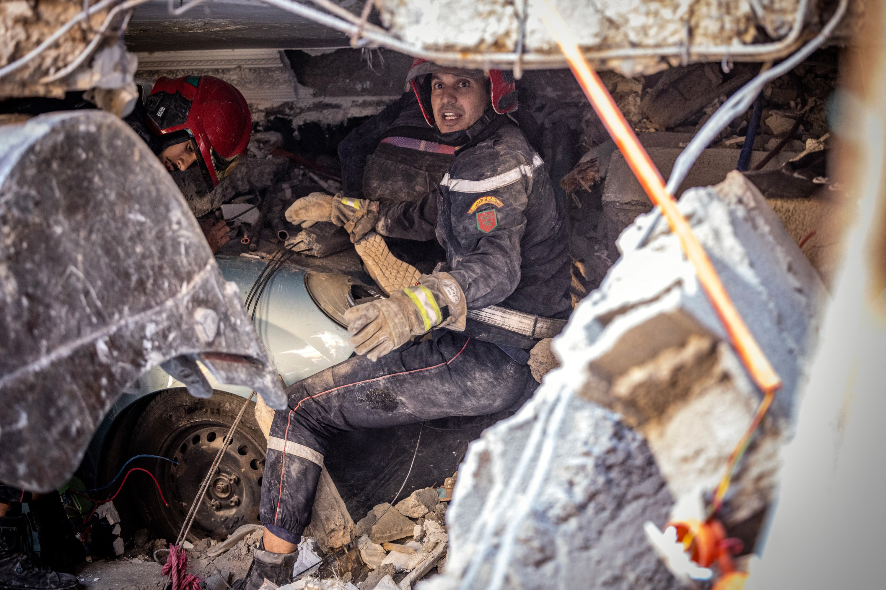 Rescue workers search for survivors in a collapsed house in Moulay Brahim, Al Haouz province (AFP)