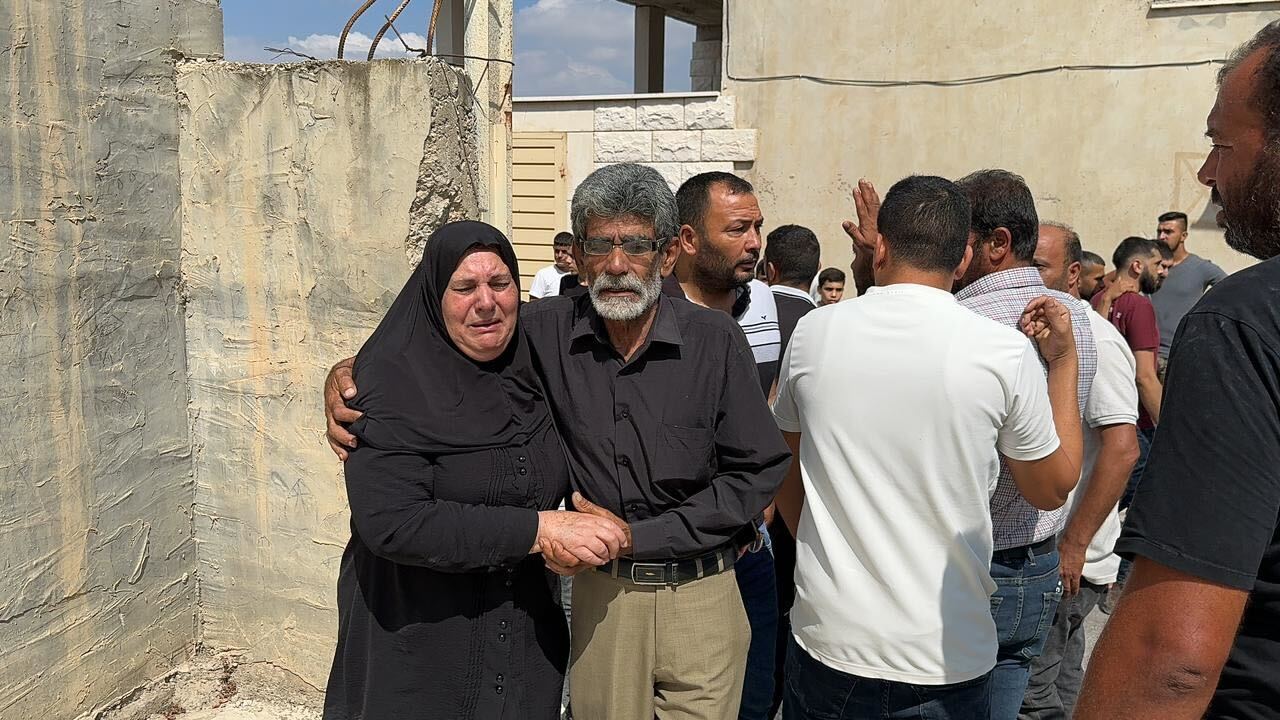 Ayman Abed's sister and brother mourn him in Kafr Dan, in the occupied West Bank on 2 September (supplied)