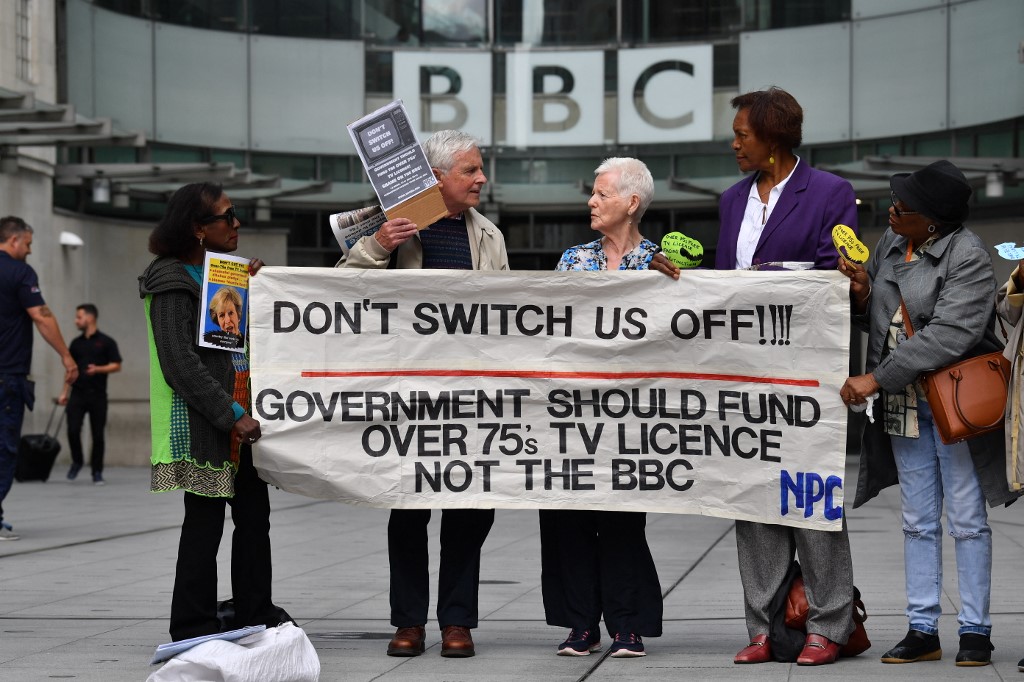 People protest outside the BBC studios in London against the end of government funding for free TV licenses for those over 75 in June 2019 (AFP)