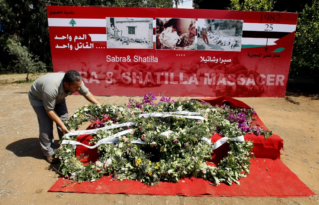 A Palestinian man lays a wreath near the graves of Palestinians killed during the 1982 massacre in Beirut’s Shatila refugee camp in September 2007 (AFP)