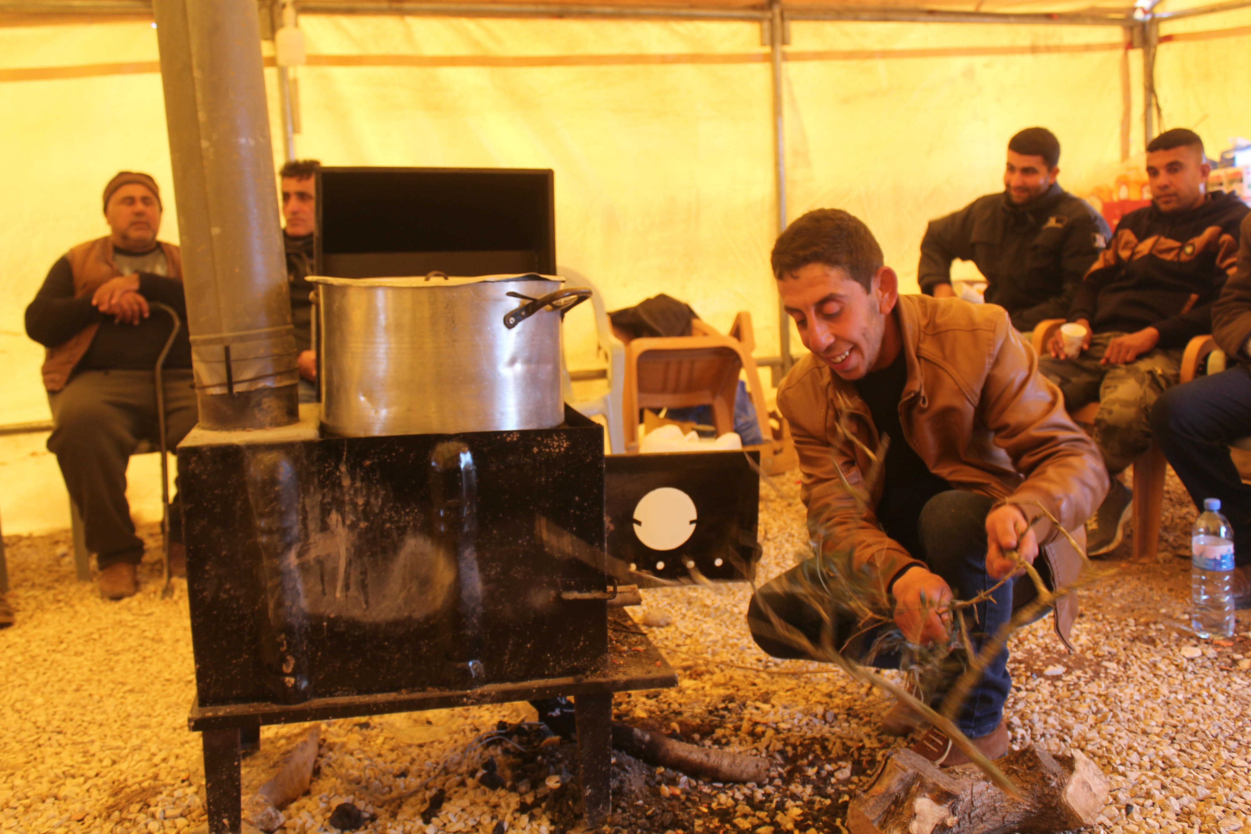 Inside the tent, volunteers make Freekeh soup, a popular Palestinian food usually prepared in the winter as it provides the body with energy and warmth (MEE/Shatha Hammad)