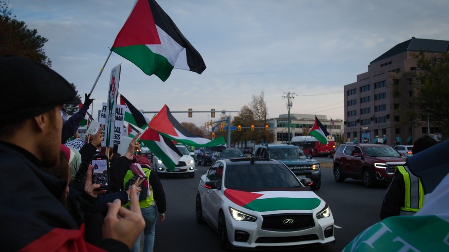 Pro-Palestinian demonstrators in cars hold up traffic trying to enter Tyson's Corner Center on Black Friday, 24 November 2023.