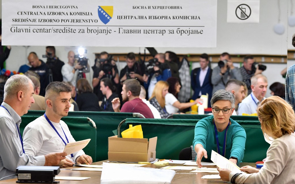 Members of Bosnia and Herzegovina’s central electoral committee recount ballots in Sarajevo on 13 October 2022 (AFP)