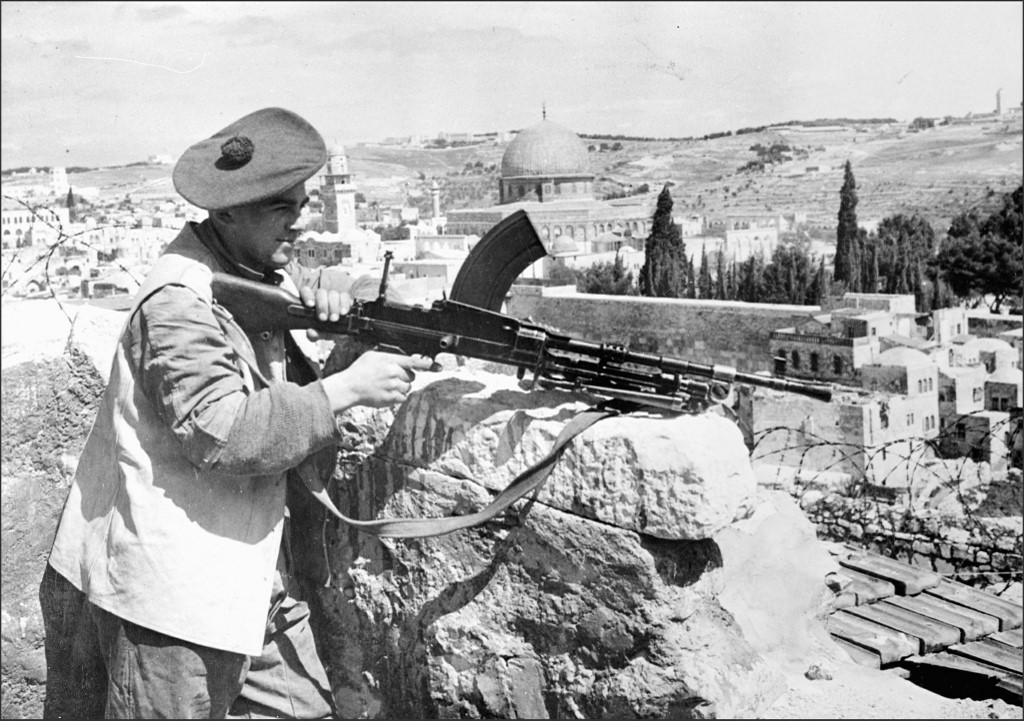 A British soldier aims a machine gun in Jerusalem during the British mandate (AFP)