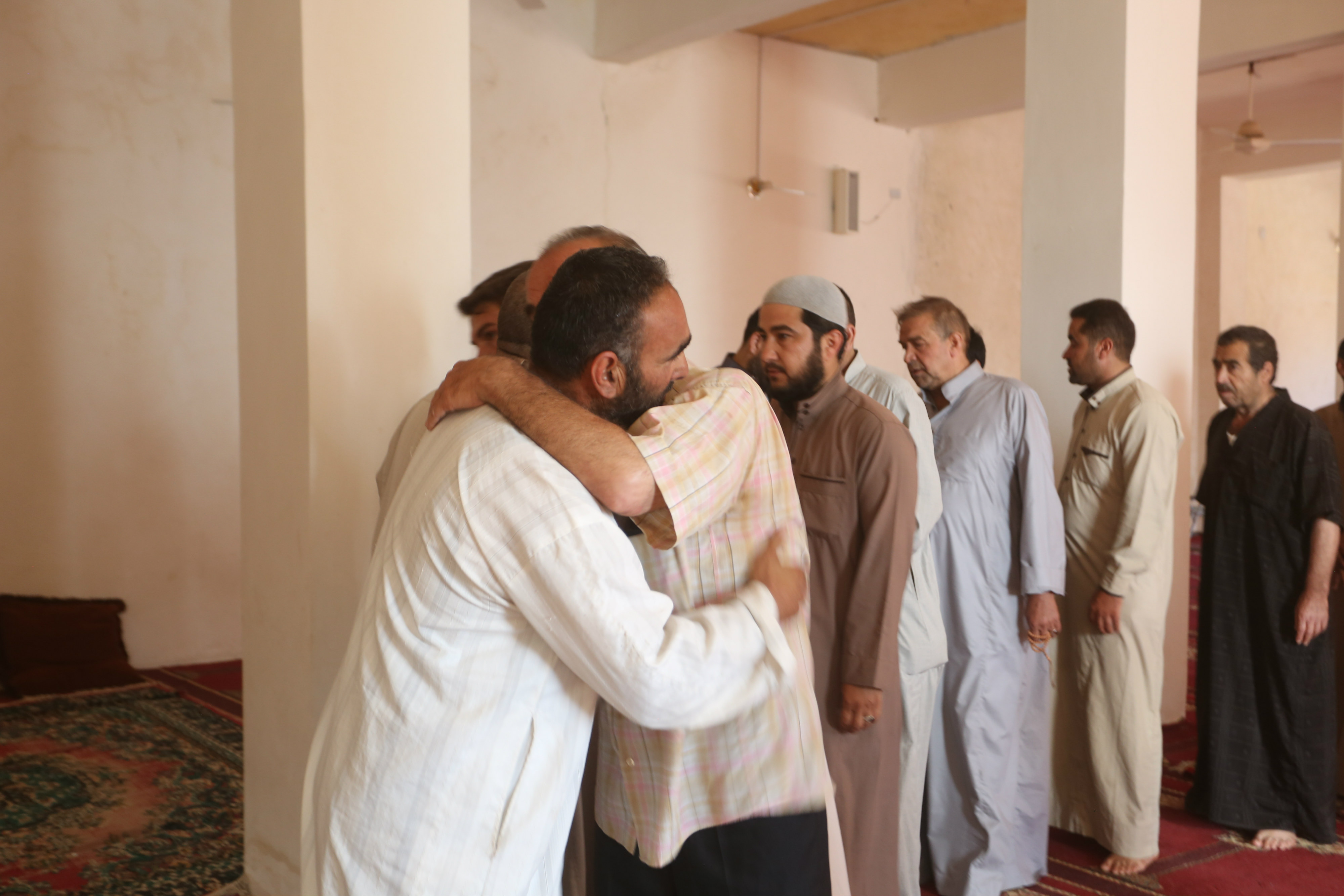 Villagers in Salwah offer condolences and prayers to Abdul Karim al-Arnos (MEE/Ali Haj Suleiman)