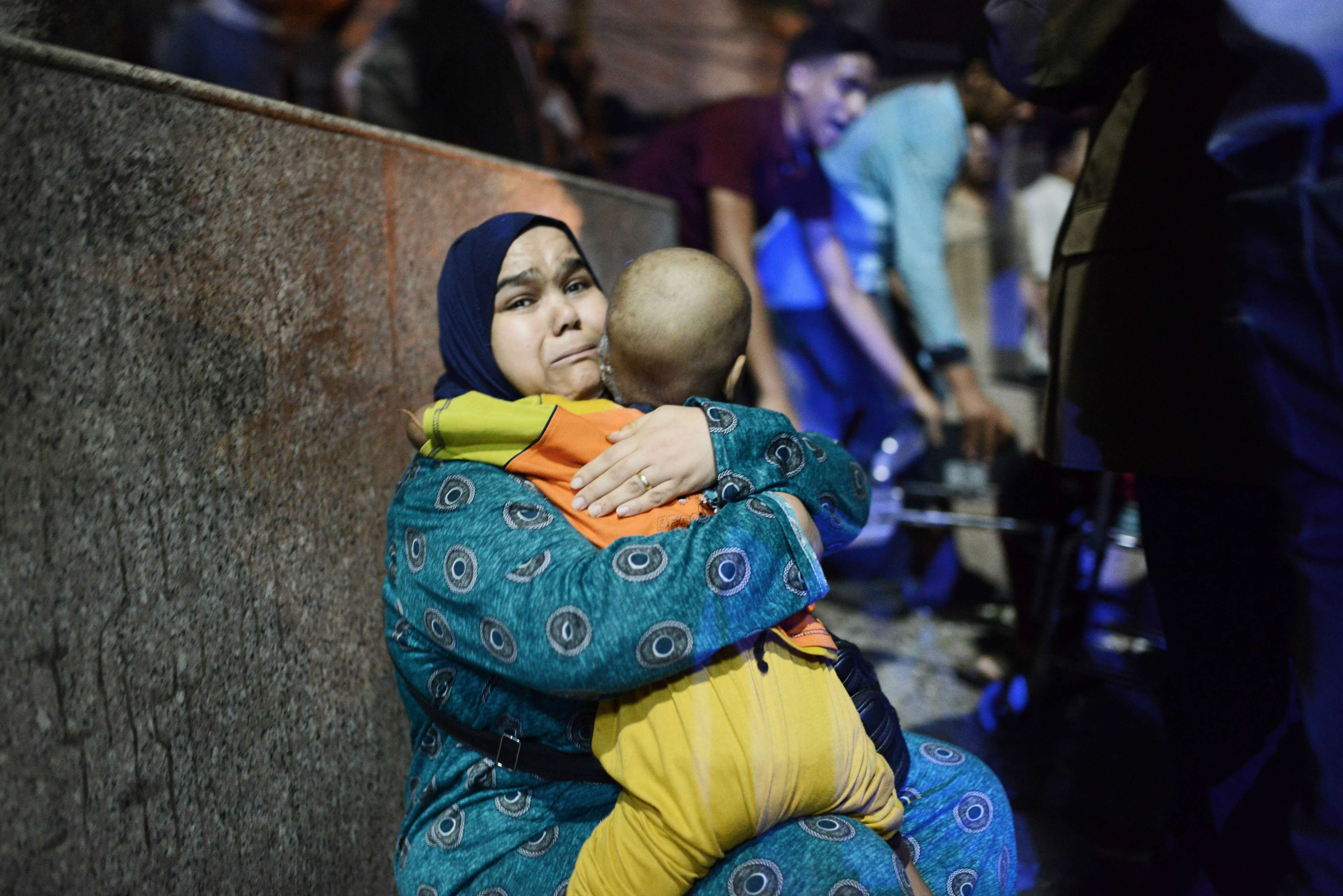 A woman carries her son, a patient at the Cancer Institute, following the blast (MEE/Jonathan Rashad)