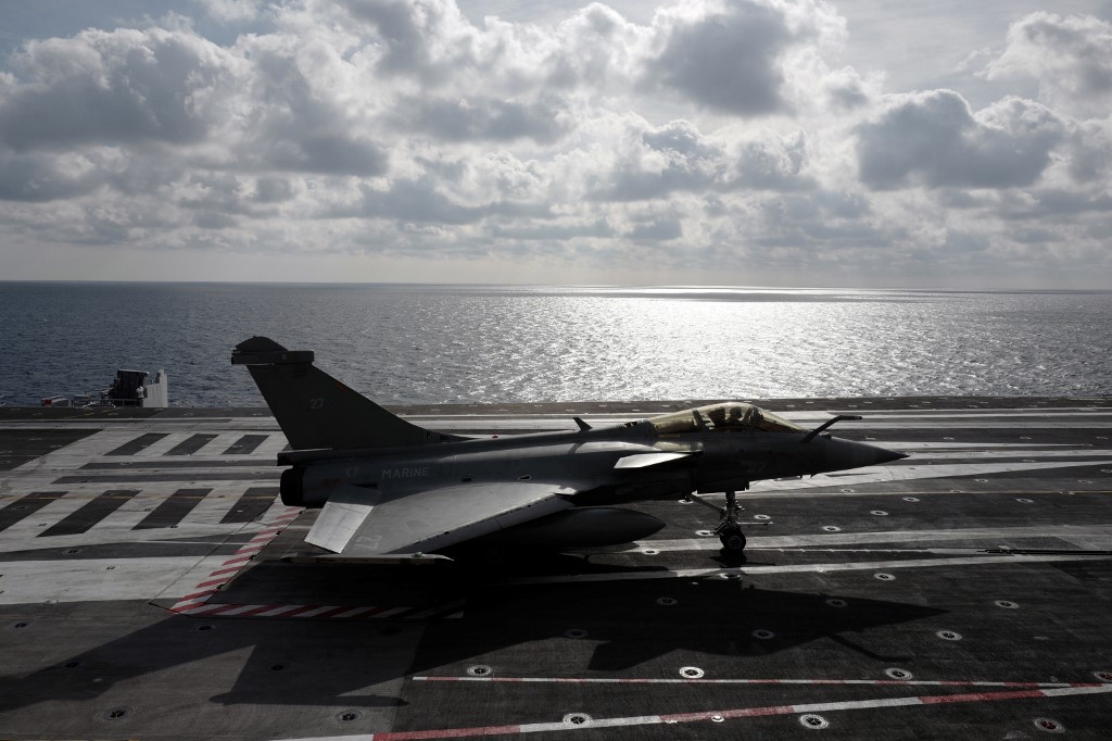 A French fighter jet lands on the Charles-de-Gaulle aircraft carrier on 7 February (AFP)