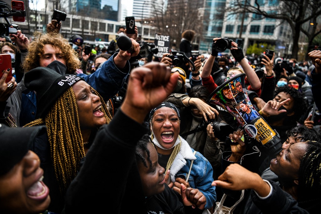 People celebrate the verdict against Derek Chauvin in Minneapolis on 20 April 2021 (AFP)