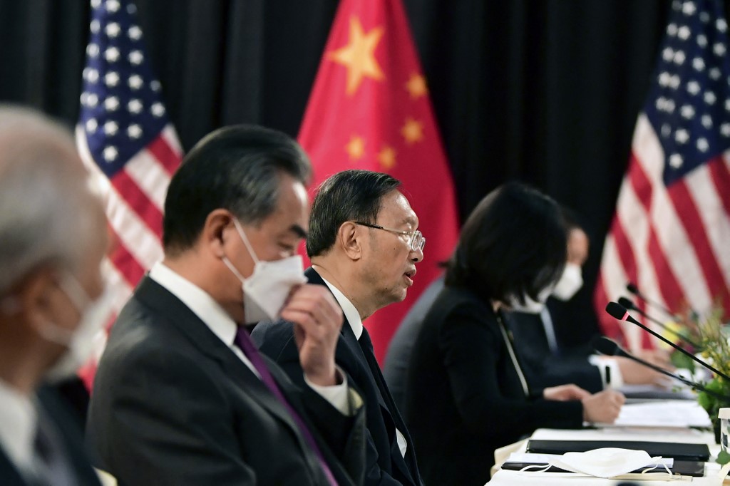 Members of a Chinese delegation led by Yang Jiechi, centre, speak with their US counterparts during talks in Anchorage, Alaska, on 18 March 2021 (AFP)