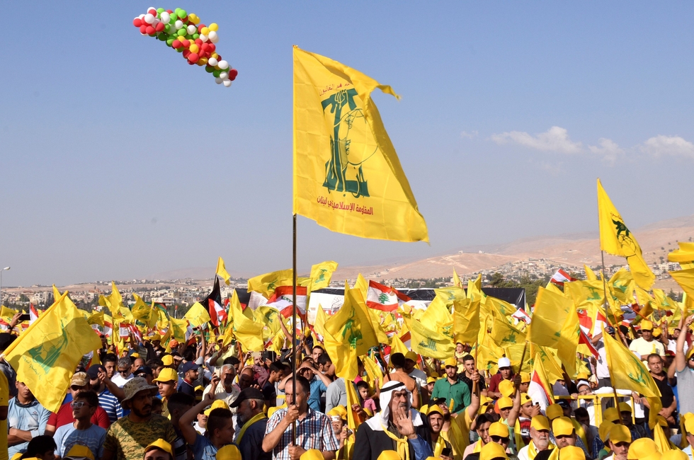 Supporters of Lebanon's Hezbollah display Hezbollah and Lebanese flags in Baalbek in eastern Lebanon, 31 August 2017